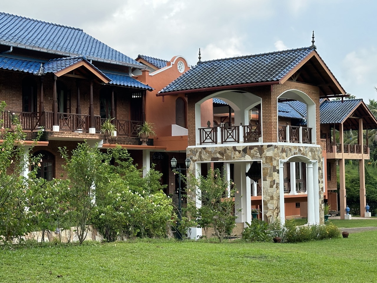 Close view of Oasis Estate facade with terracotta, stone, and traditional tiled roof