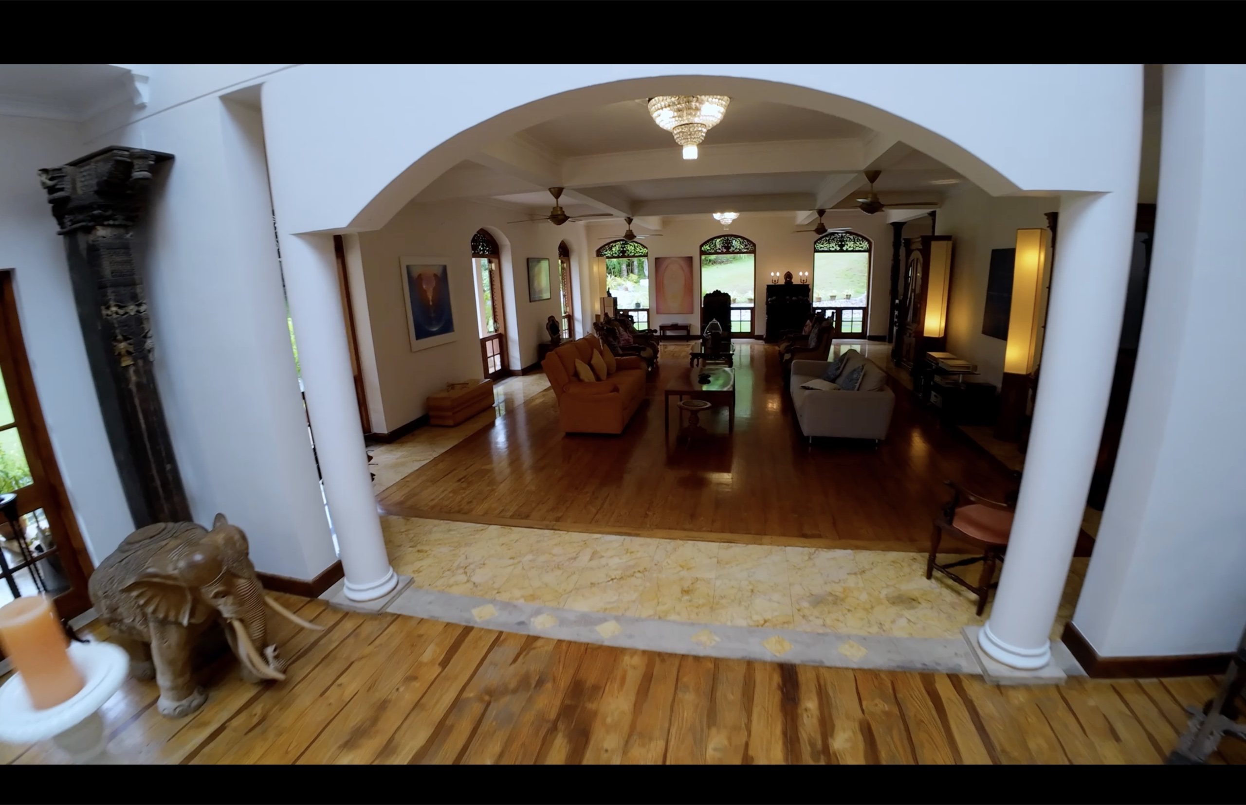 Principal living room with teak joinery and garden views at Oasis Estate