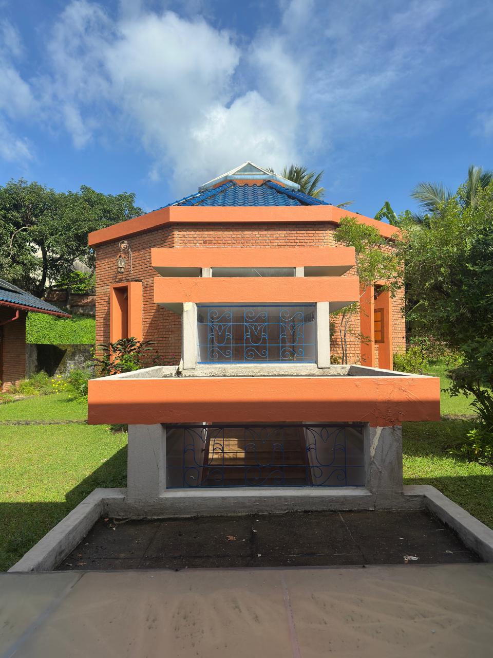 Octagonal meditation pavilion set within bamboo and mature garden planting at Oasis Estate