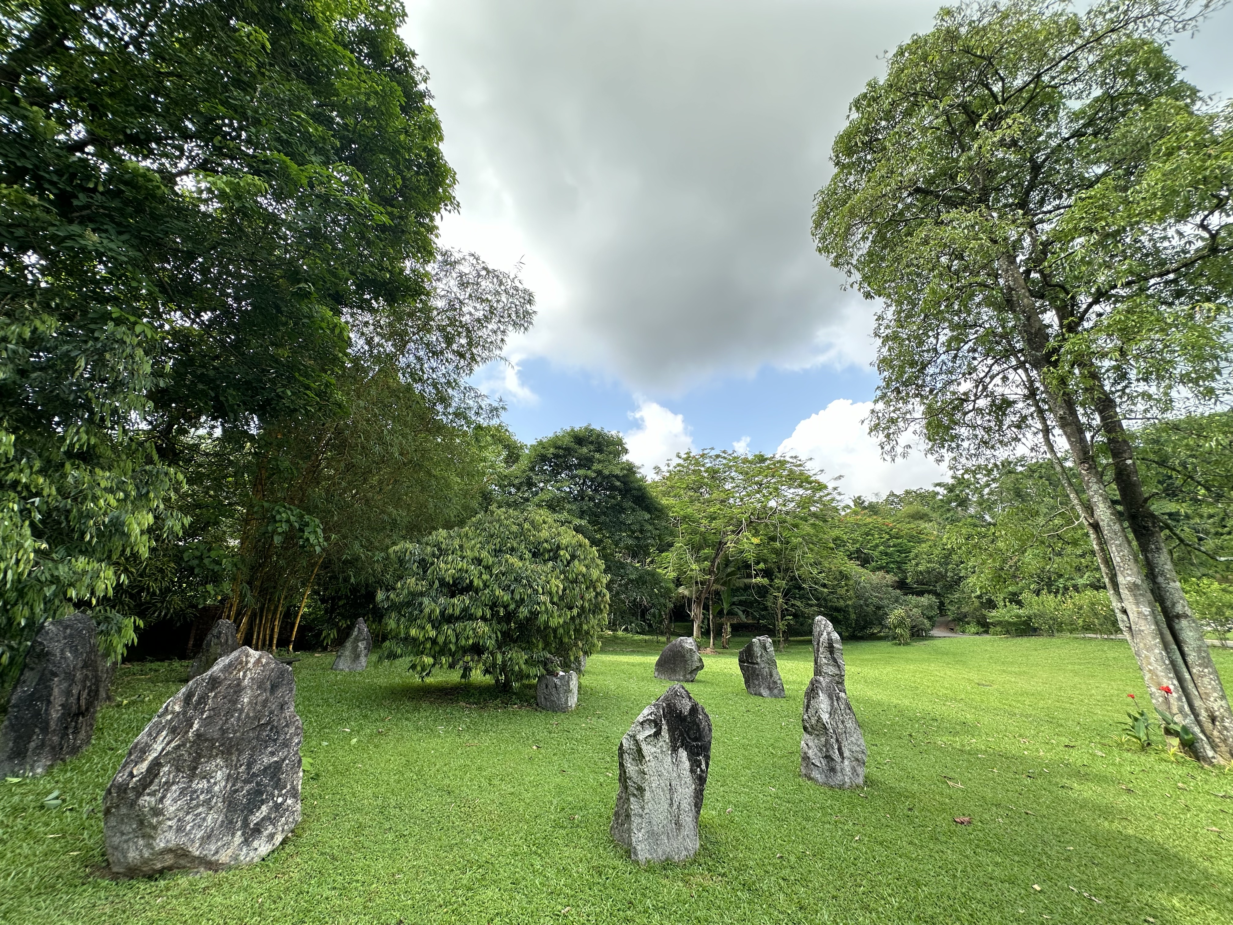 Sculptural standing stones within the bamboo-shaded garden at Oasis Estate
