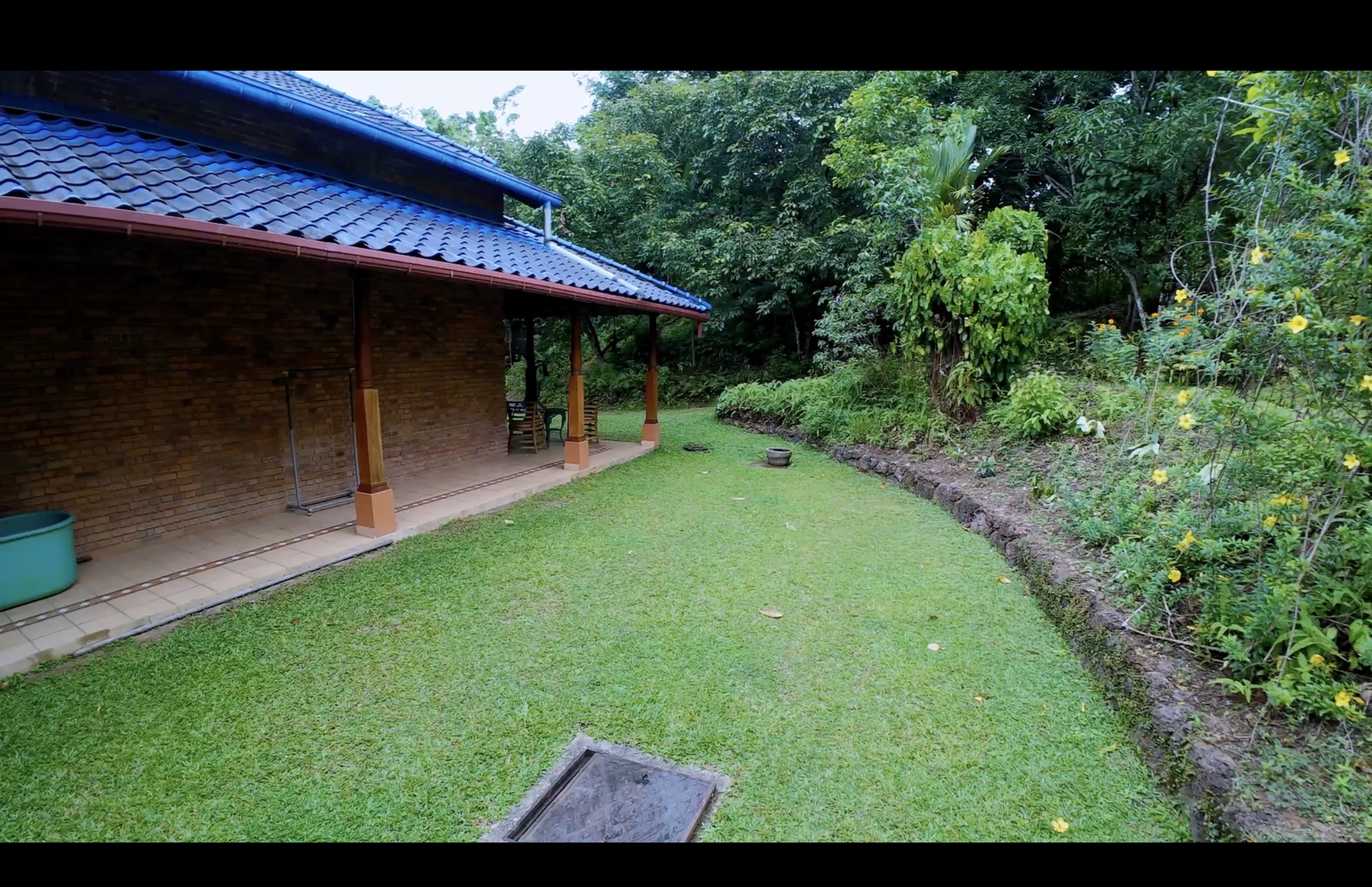 Landscaped west wing gardens with mature tropical planting at Oasis Estate